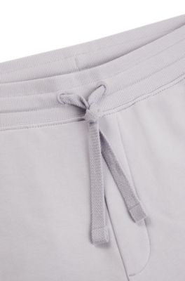 Pantalones de ch&aacute;ndal en felpa de algod&oacute;n con pu&ntilde;os y logo estampado, Luz p&uacute;rpura