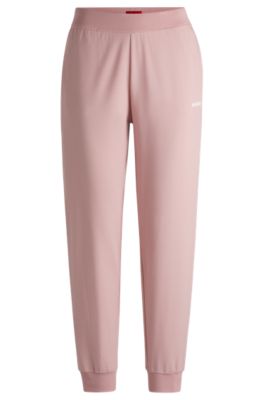 Cuffed tracksuit bottoms with logo print, light pink