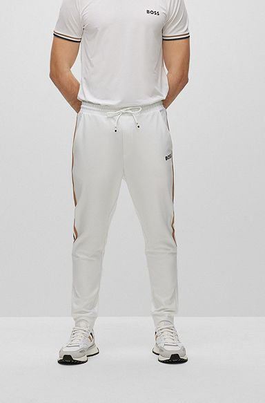 BOSS x Matteo Berrettini Tracksuit bottoms in active-stretch fabric with side stripes, White