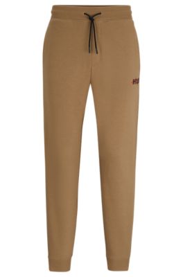 Shop Hugo Monogram-print Tracksuit Bottoms With Striped Tape In Light Brown