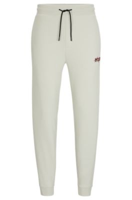 Hugo Boss Monogram-print Tracksuit Bottoms With Striped Tape In Light Green