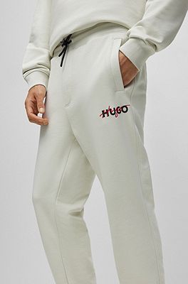 BOSS - Monogram-print tracksuit bottoms with signature-stripe tape