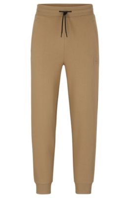 Hugo Boss Cuffed Tracksuit Bottoms In French Terry With Logo Badge In Light Brown