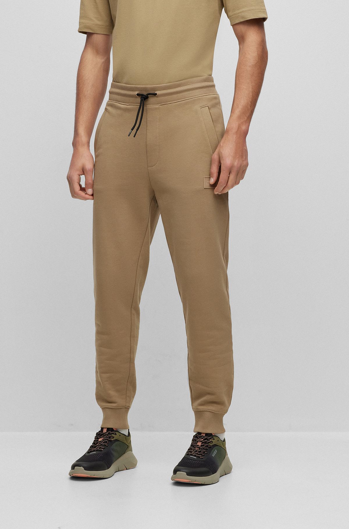 Cuffed tracksuit bottoms in French terry with logo badge, Light Brown