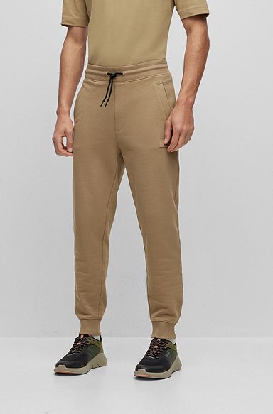 Cuffed tracksuit bottoms in French terry with logo badge, Light Brown
