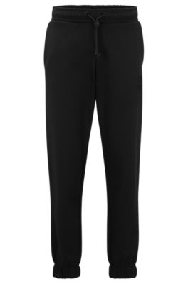 Hugo Boss Relaxed-fit Cotton-terry Tracksuit Bottoms With Stacked Logo In Black