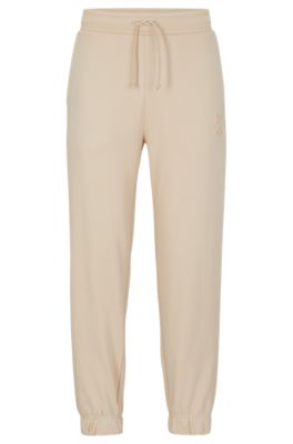 Hugo Boss Mens Boss Logo-embroidery Relaxed-fit Recycled-polyester Blend Stretch-borg Jogging Bottoms In Light Beige