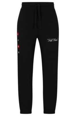 HUGO BOSS COTTON-TERRY TRACKSUIT BOTTOMS WITH PLAYING-CARD ARTWORK