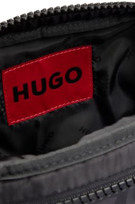 Stacked-logo-pattern reporter bag with branded rubber patch, Black