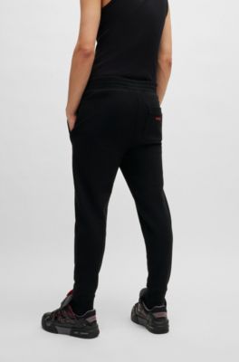 Pantalones de ch&aacute;ndal de felpa de algod&oacute;n con logo con llamas en relieve, Negro