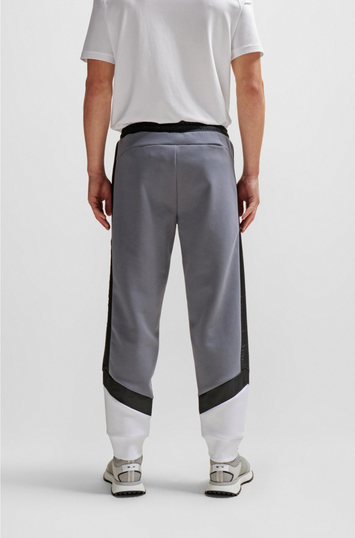 Mixed-material tracksuit bottoms with printed logo