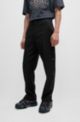 Pantalon Slim Fit avec coutures latérales cloutées, Noir