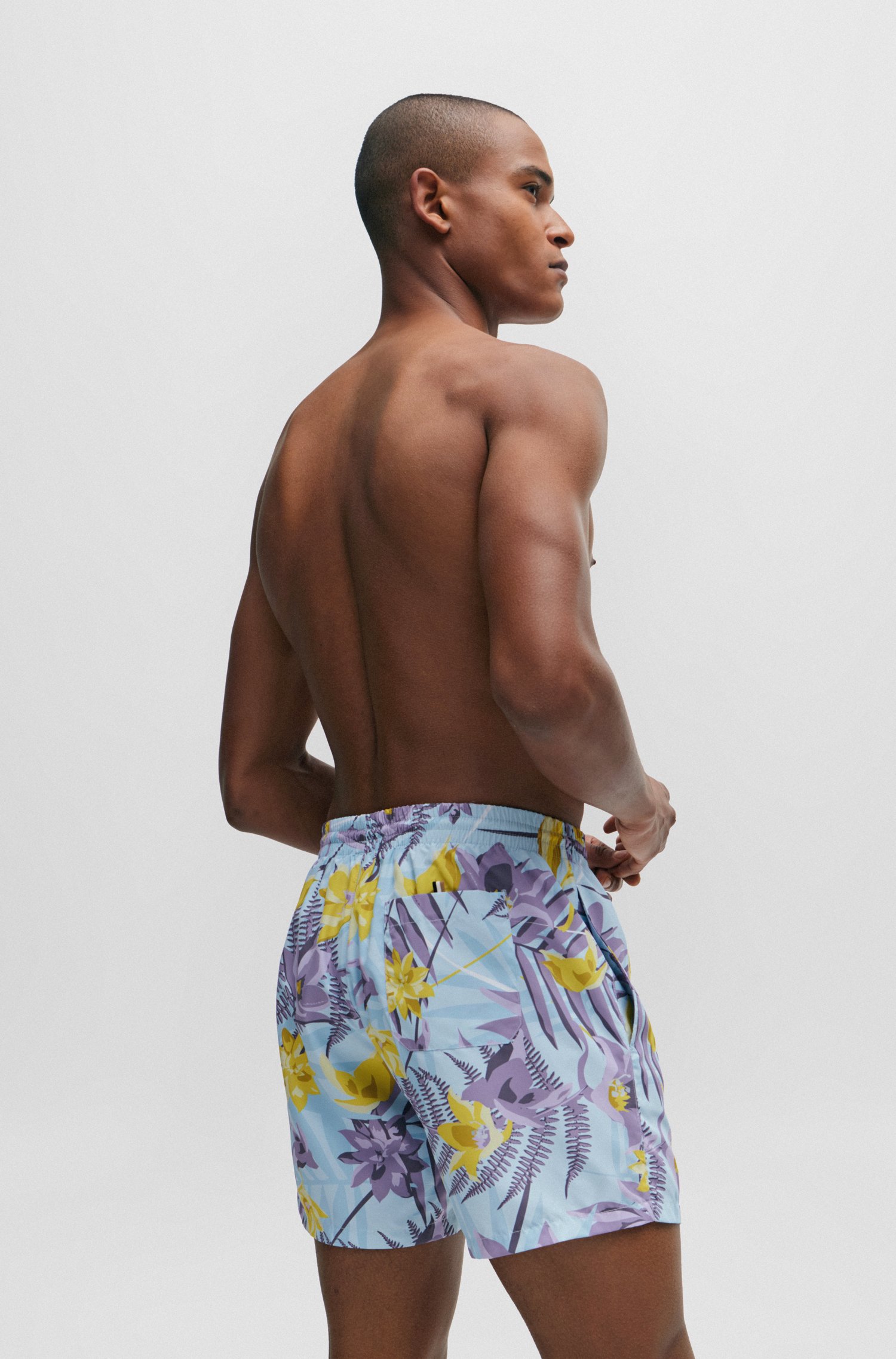 Tropical-print quick-drying swim shorts with logo badge