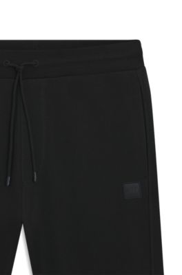 Bas de surv&ecirc;tement en molleton de coton avec patch logo, Noir