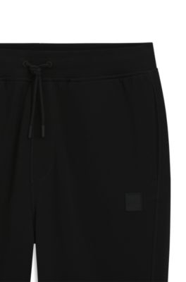 Pantalones de ch&aacute;ndal en felpa de algod&oacute;n con aplique de logo, Negro