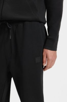 Pantalones de ch&aacute;ndal en felpa de algod&oacute;n con aplique de logo, Negro