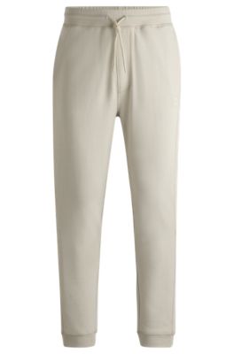 Shop Hugo Boss Cotton-terry Tracksuit Bottoms With Logo Patch In Light Beige