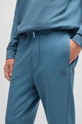 Pantalones de ch&aacute;ndal en felpa de algod&oacute;n con parche de logo, Celeste