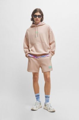 Cotton-terry oversize-fit hoodie with seasonal logos, light pink