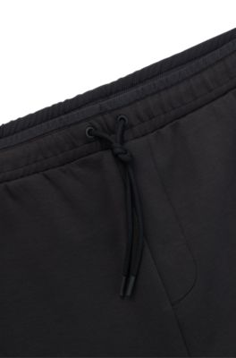 Pantalones de ch&aacute;ndal de algod&oacute;n con logo moldeado en relieve, Gris oscuro