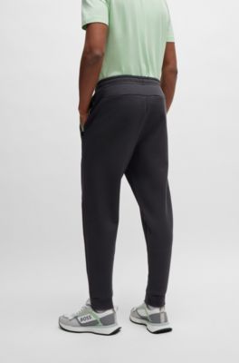 Pantalones de ch&aacute;ndal de algod&oacute;n con logo moldeado en relieve, Gris oscuro