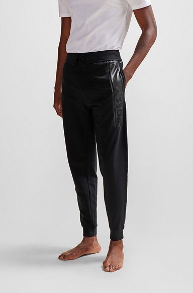 Pantalon de survêtement en molleton resserré au bas des jambes, avec logo imprimé, Noir