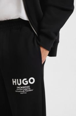 Logo-print tracksuit bottoms in cotton terry, Black