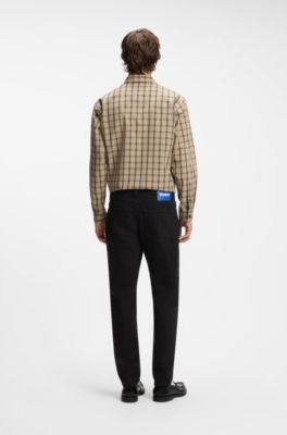 Vaqueros tapered fit en denim el&aacute;stico negro, Negro