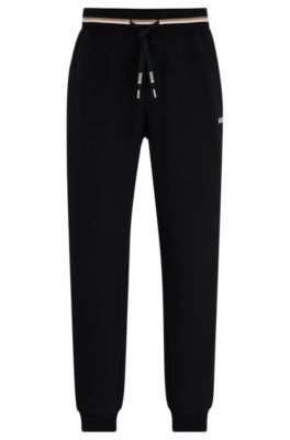Shop Hugo Boss Tracksuit Bottoms With Stripes And Logos In Black