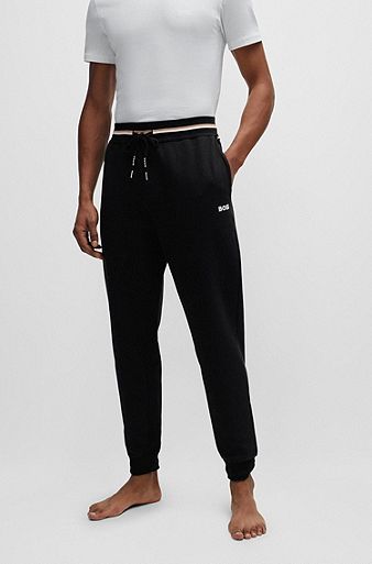 Tracksuit bottoms with stripes and logos, Black
