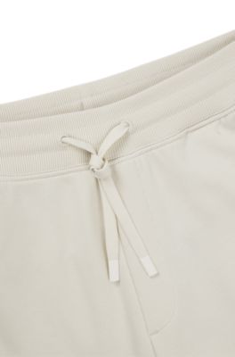 Cotton-terry tracksuit bottoms with logo print, White