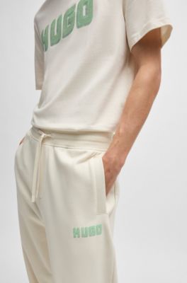 Cotton-terry tracksuit bottoms with logo print, White