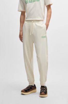Cotton-terry tracksuit bottoms with logo print, White