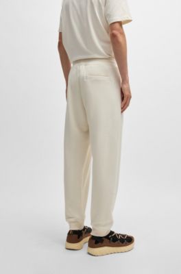 Cotton-terry tracksuit bottoms with logo print, White