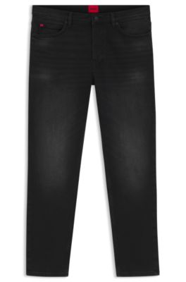 Jeans tapered fit de denim el&aacute;stico negro, Negro