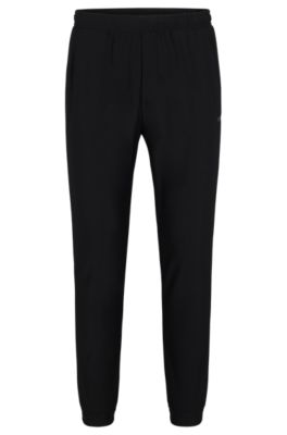 Tracksuit bottoms in stretch fabric with decorative reflective logo, Black