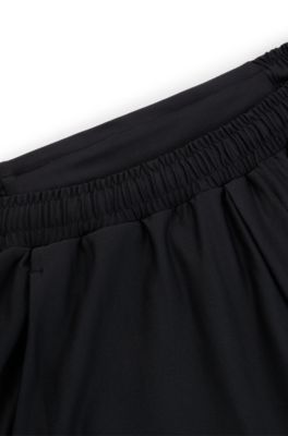 Tracksuit bottoms in stretch fabric with decorative reflective logo, Black