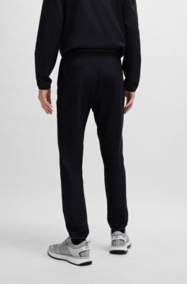 Tracksuit bottoms in stretch fabric with decorative reflective logo, Black
