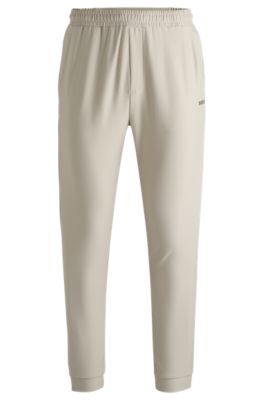 Tracksuit bottoms in stretch fabric with decorative reflective logo, Light Beige
