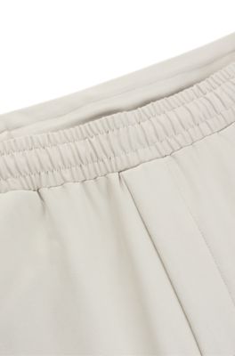 Tracksuit bottoms in stretch fabric with decorative reflective logo, Light Beige