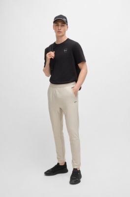 Tracksuit bottoms in stretch fabric with decorative reflective logo, Light Beige