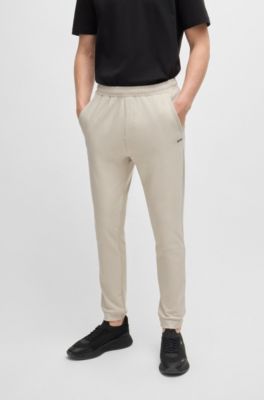 Tracksuit bottoms in stretch fabric with decorative reflective logo, Light Beige