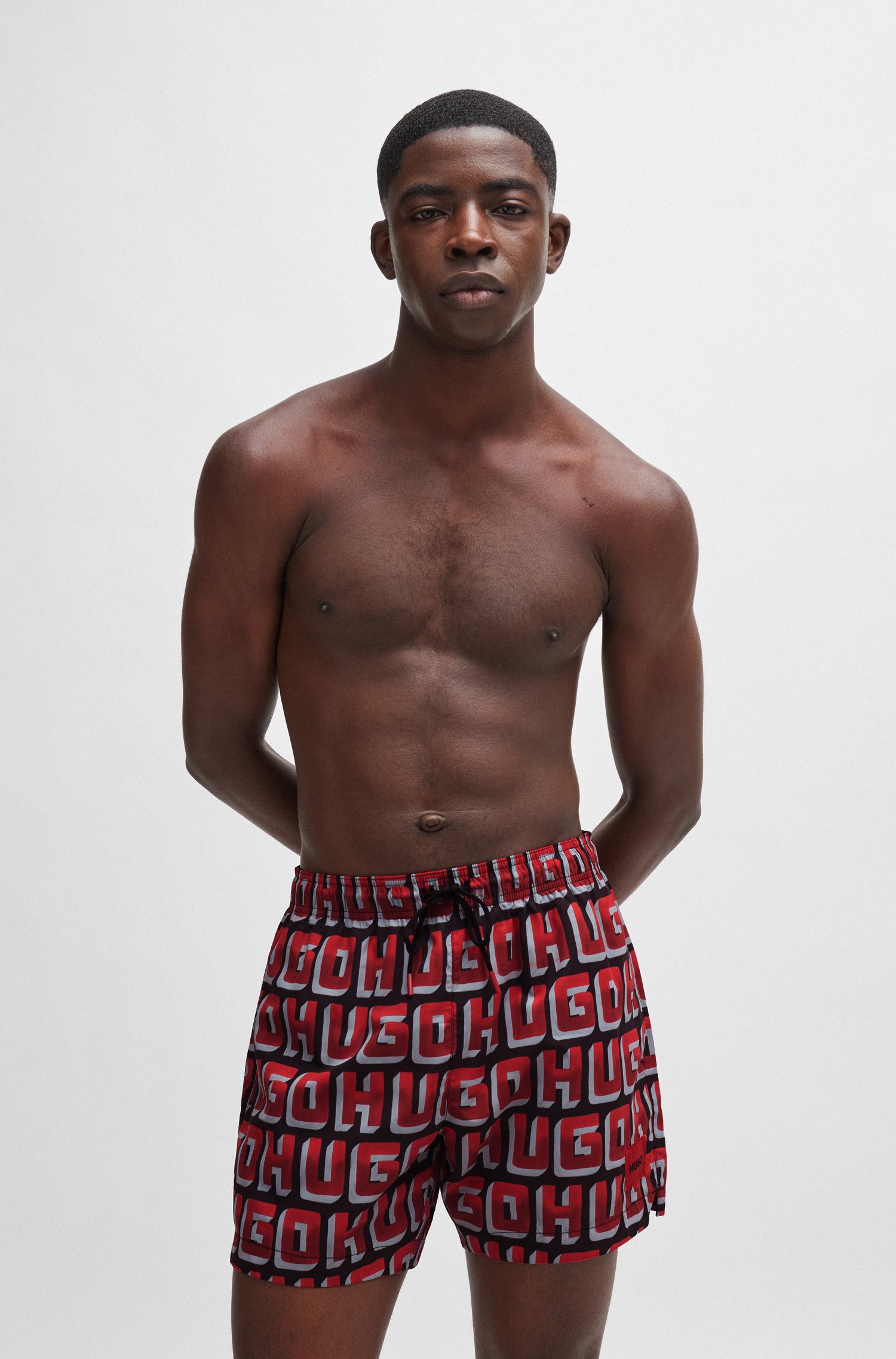 Quick-dry swim shorts with all-over logo print