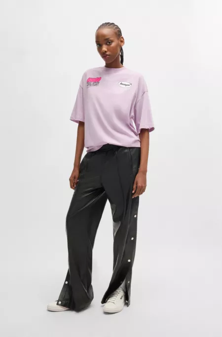 Straight-leg trousers in faux leather with press-studs