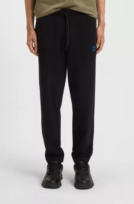 Cotton-terry tracksuit bottoms with Happy HUGO
