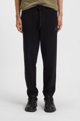 Cotton-terry tracksuit bottoms with Happy HUGO, Black