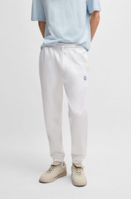 Cotton-terry tracksuit bottoms with Happy HUGO, White