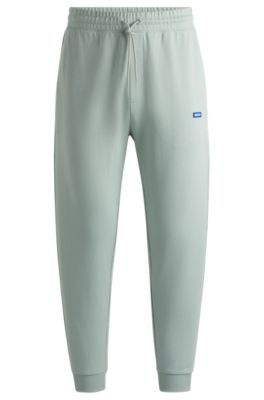 Shop Hugo Cotton-terry Tracksuit Bottoms With Blue Logo Patch In Light Green