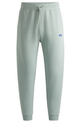 Hugo Boss Cotton-terry Tracksuit Bottoms With Blue Logo Patch In Light Green