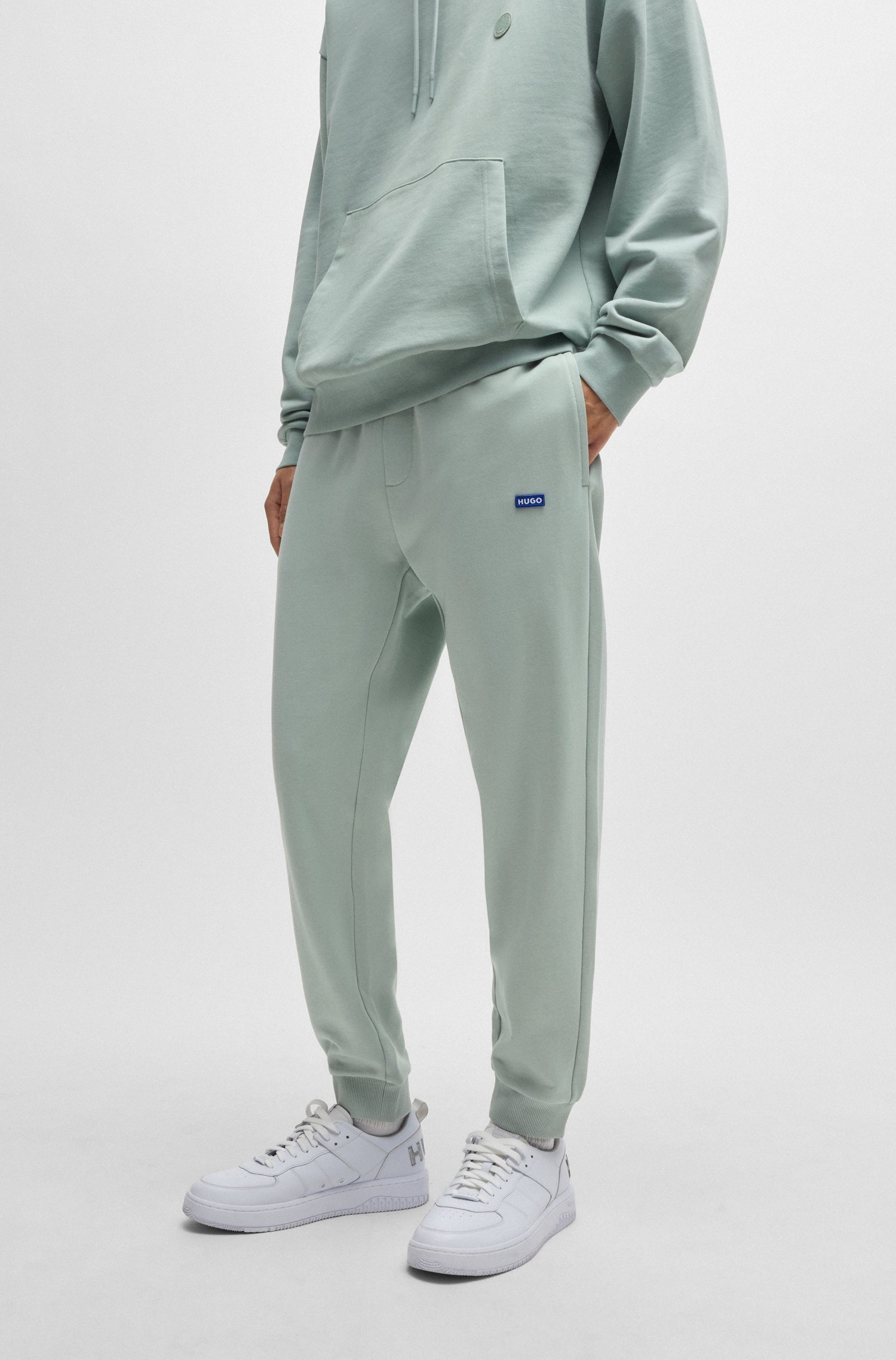 Cotton-terry tracksuit bottoms with blue logo patch